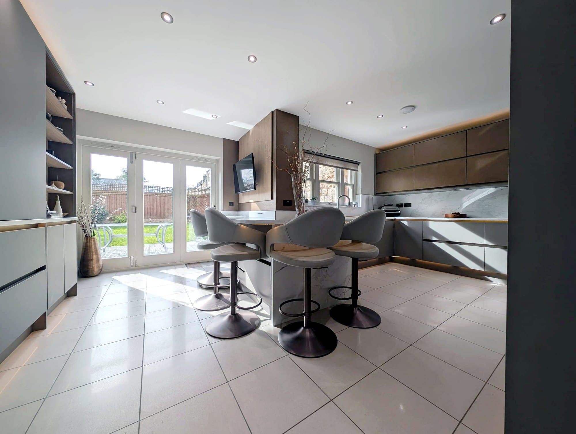 Bright handleless fitted kitchen with island